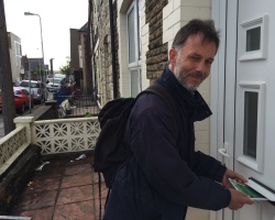 Christopher von Ruhland slides in a leaflet into a mail box on Cardiff's Donald Street.